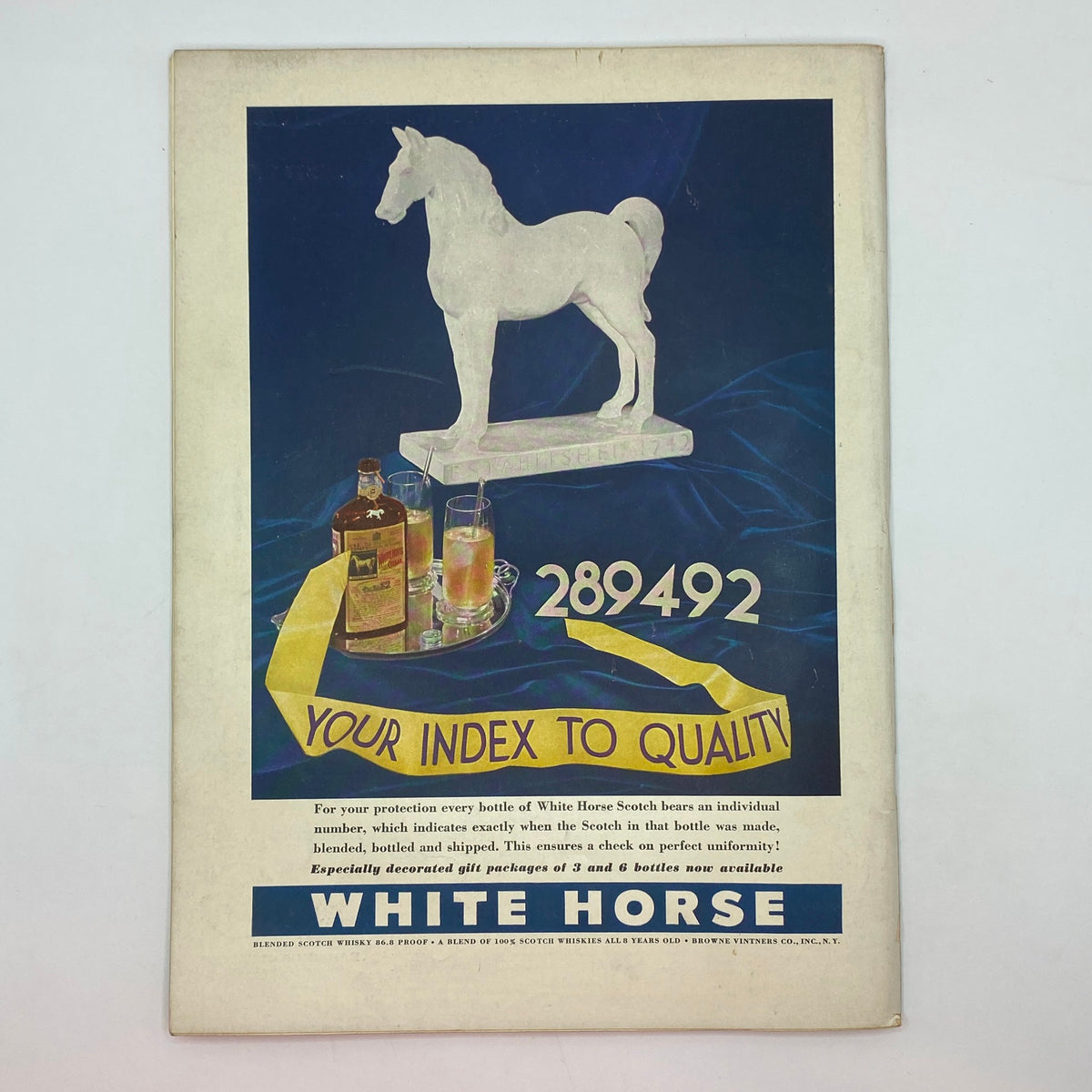 Back cover of The New Yorker magazine from December 3, 1938, advertising White Horse Scotch whiskey with a striking horse statue design and vibrant colors, reflecting the advertising style of the 1930s, part of the Perry Barlow cover issue.