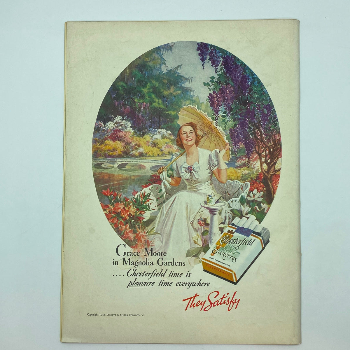 Grace Moore Chesterfield cigarette advertisement in The New Yorker magazine July 30, 1938 showcasing a woman in a garden with a parasol.