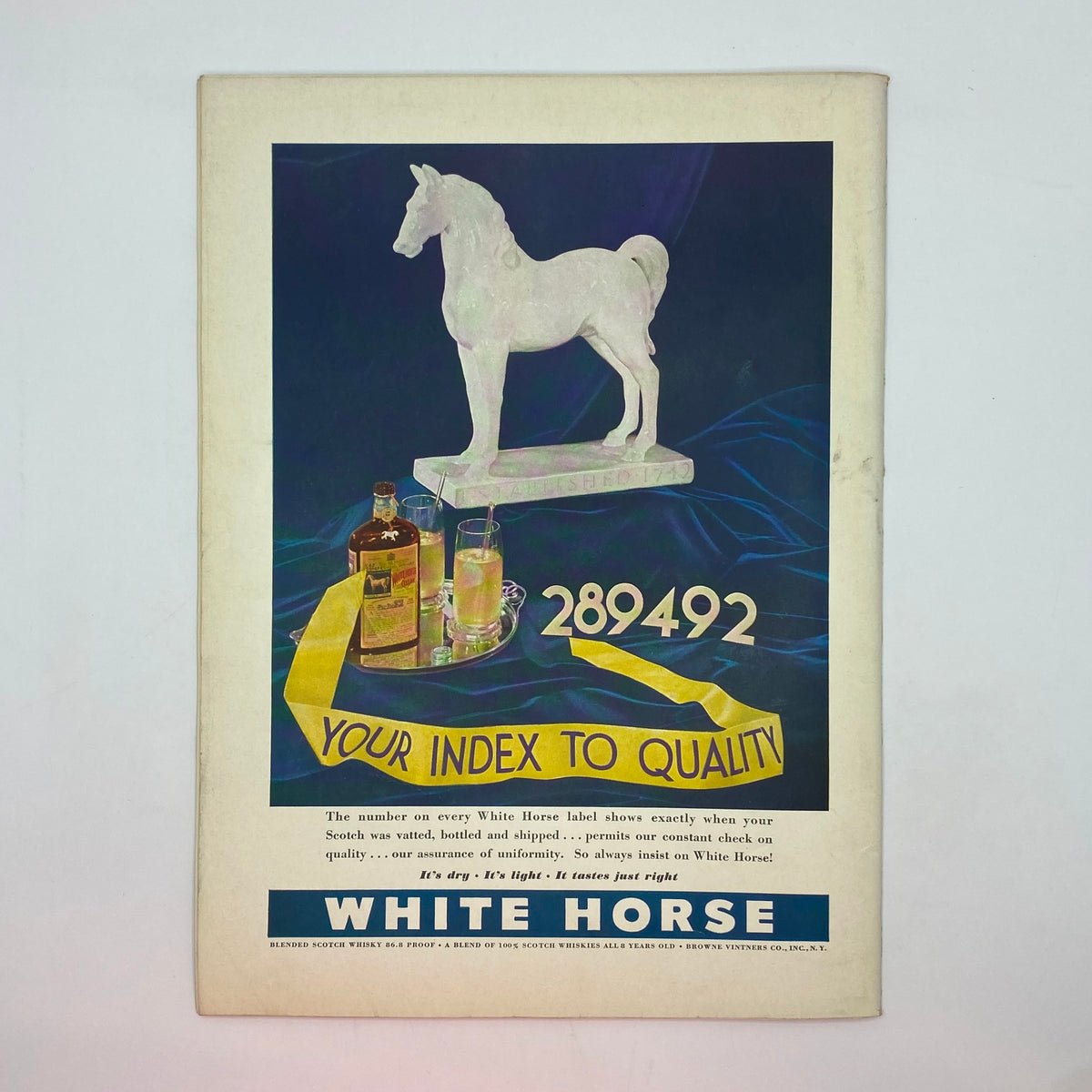 Vintage advertisement featuring a decorative horse statue for White Horse Scotch whisky, alongside glasses and a bottle, from The New Yorker Complete Magazine October 15, 1938.