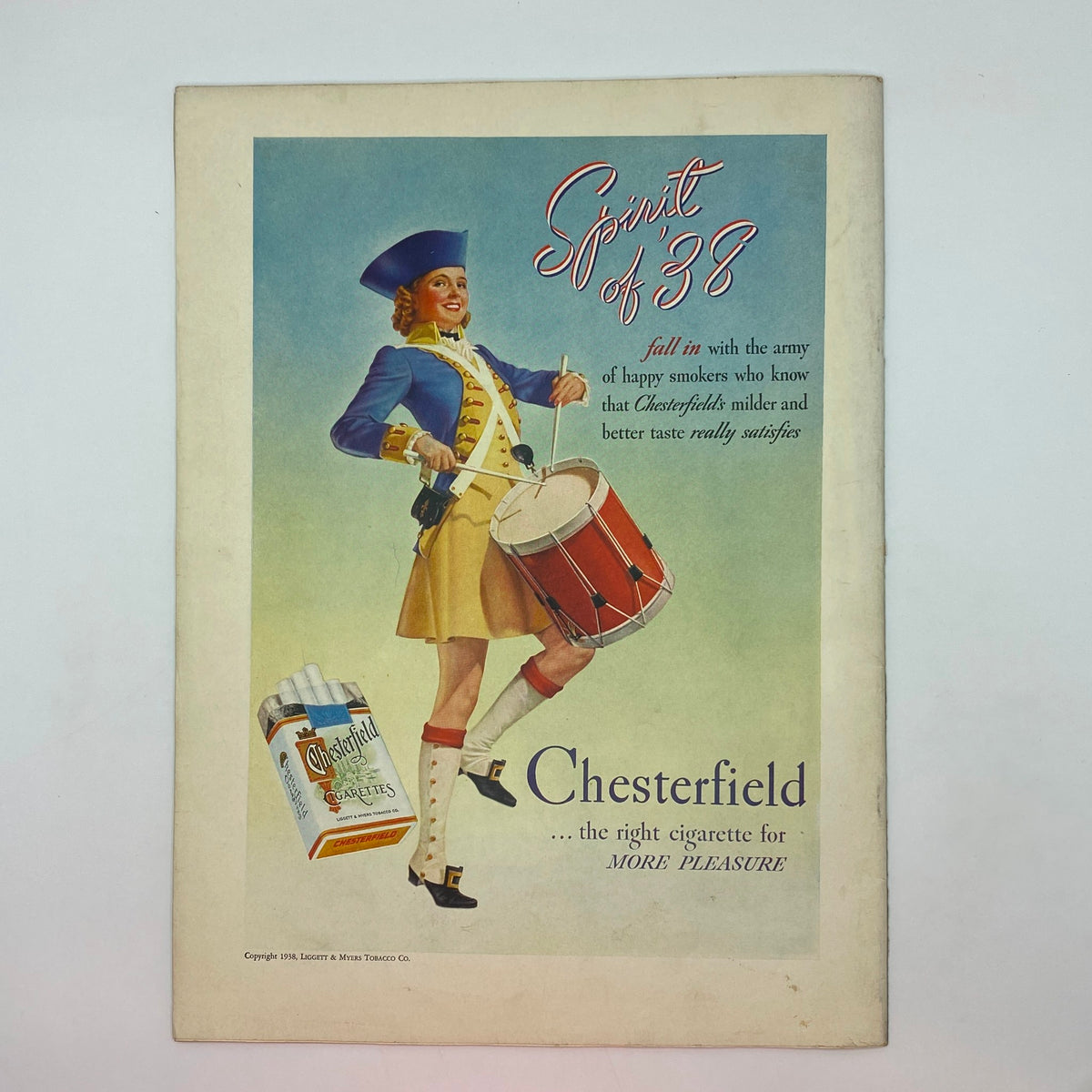 Chesterfield cigarette advertisement from The New Yorker Complete Magazine July 2, 1938, featuring a drummer girl in patriotic attire. This vintage ad highlights the promotional style of the era.