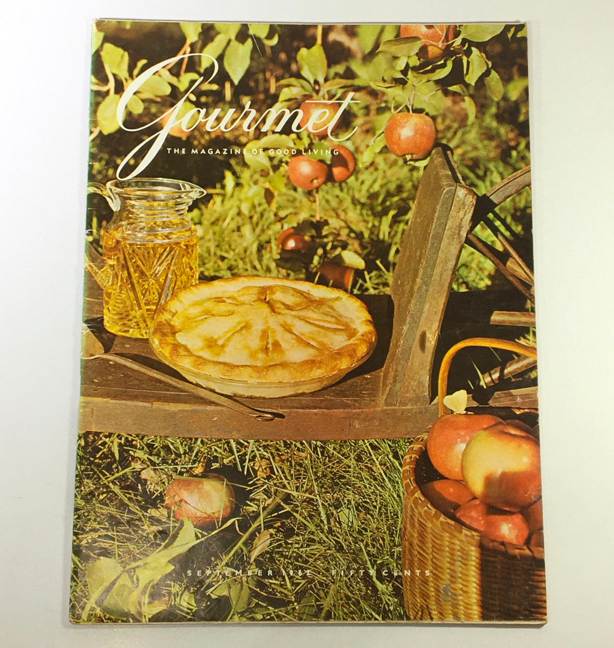 Cover of VTG Gourmet The Magazine of Good Living September 1962 featuring a rustic table setting with a pie and apples, embodying the essence of mid-century dining.