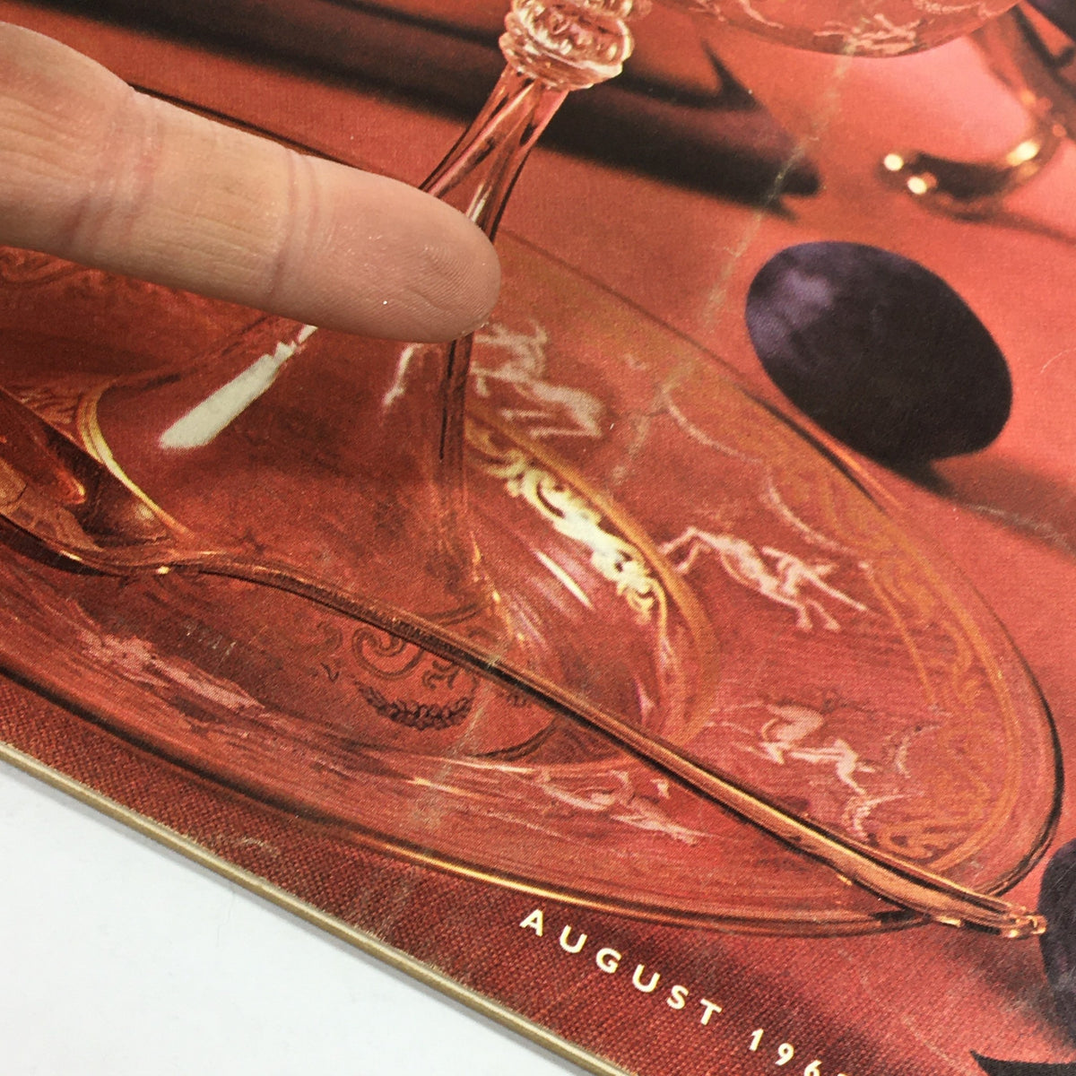 Close-up of the glassware featured on the cover of VTG Gourmet The Magazine of Good Living August 1962, showcasing intricate detailing and vintage design elements.