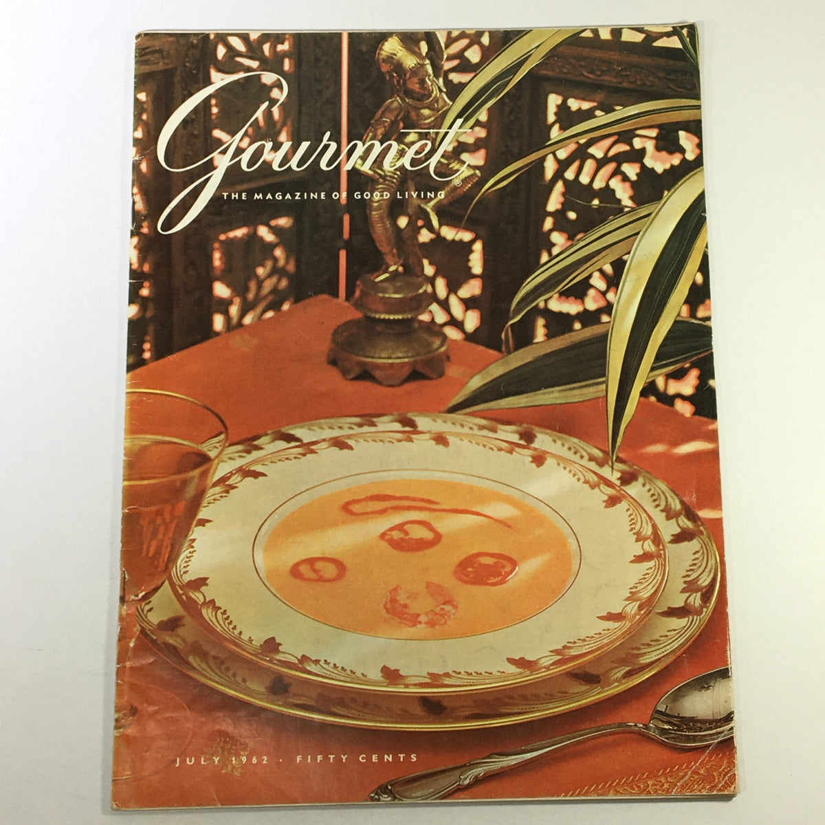 Cover of VTG Gourmet The Magazine of Good Living July 1962 featuring vibrant presentation of a plate and glass on a decorative table setting.