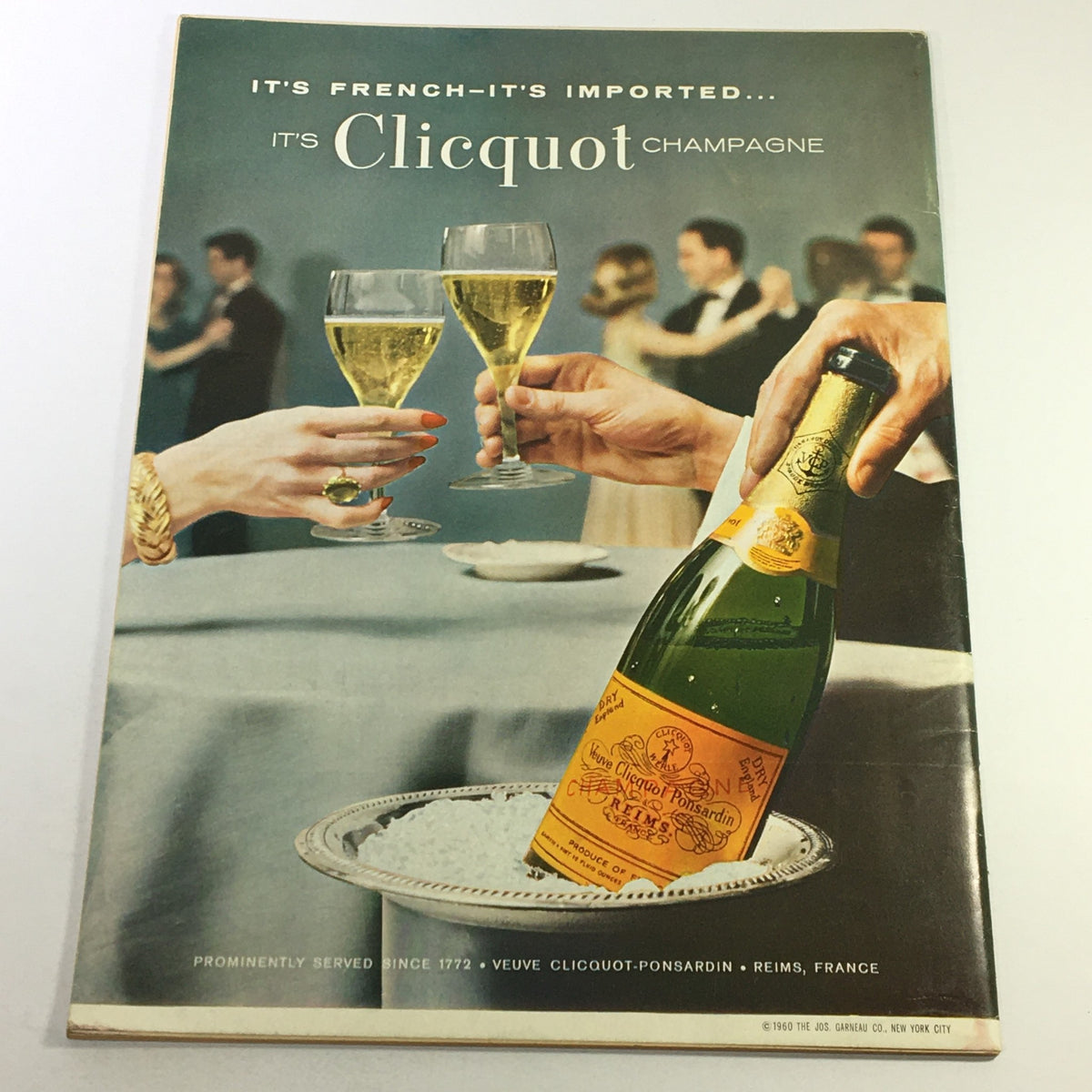 Vintage Clicquot Champagne advertisement showcasing elegantly dressed couples toasting. Part of the April 1963 Gourmet magazine illustrating the social chic of the era.