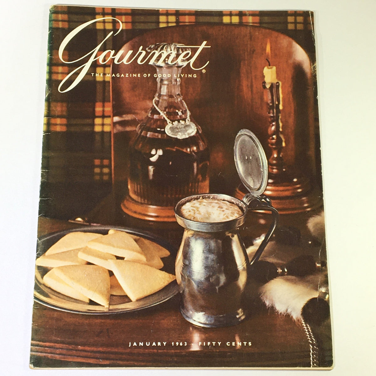 Cover of VTG Gourmet The Magazine of Good Living January 1963 featuring a vintage scene with cookies and a drink in a metal container, evoking a sense of culinary nostalgia.
