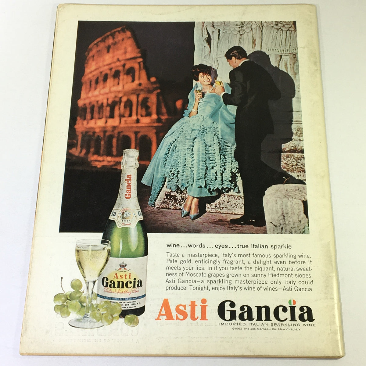 Back cover of VTG Gourmet: The Magazine of Good Living April 1964 featuring an advertisement for Asti Gancia sparkling wine with a couple in an Italian setting.