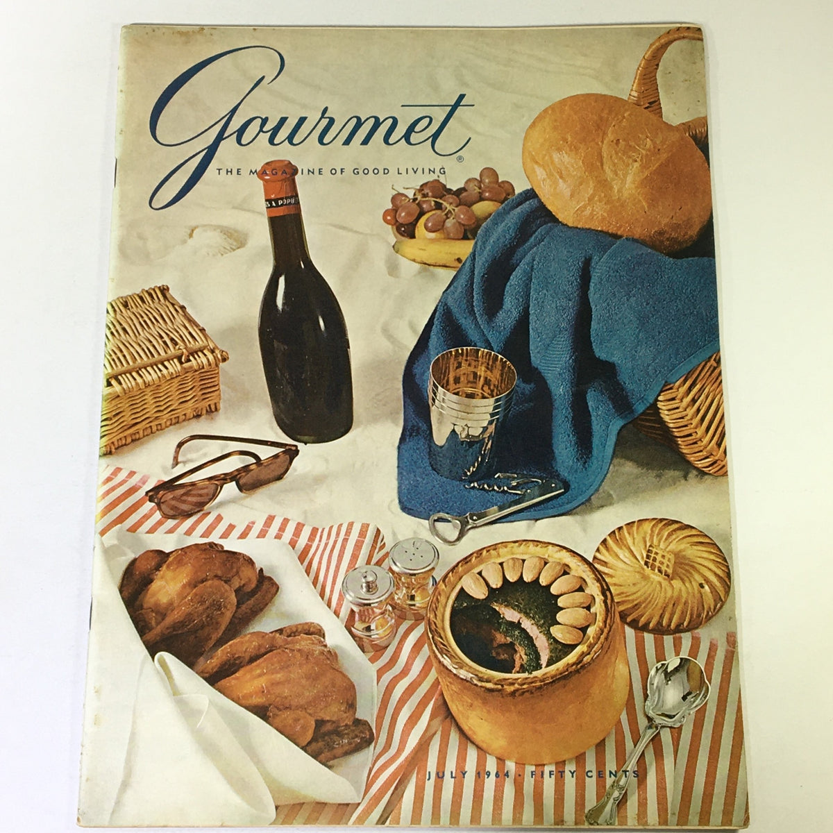 VTG Gourmet The Magazine of Good Living July 1964 cover featuring a vintage table setting with bread, wine, and gourmet delicacies.