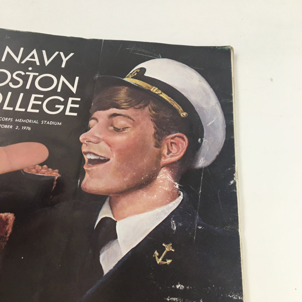 Detailed look at the sailor on the 1976 Navy Boston College program cover, emphasizing condition and vintage design elements.