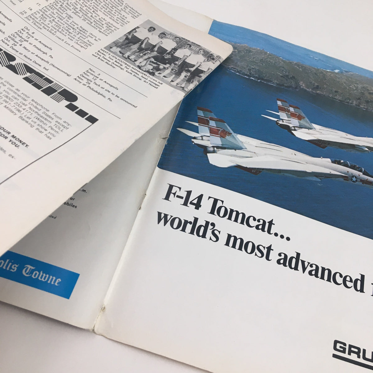 1976 Navy Boston College Navy-Marine Corps Memorial Stadium Program showcasing an F-14 Tomcat fighter jet, emphasizing its advanced features.