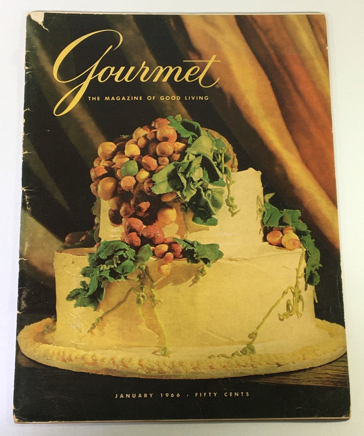 Cover of VTG Gourmet The Magazine of Good Living January 1966 featuring a beautifully styled cake with grapes and greenery.