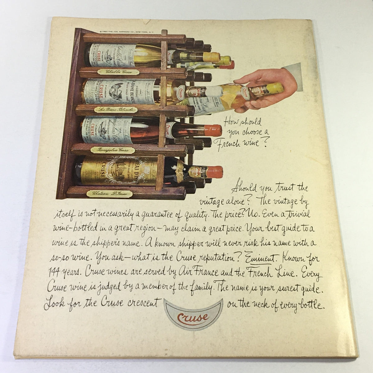 Back cover of VTG Gourmet Magazine July 1968 showcasing a wine rack display with various vintage wine bottles and handwritten notes about choosing French wine.