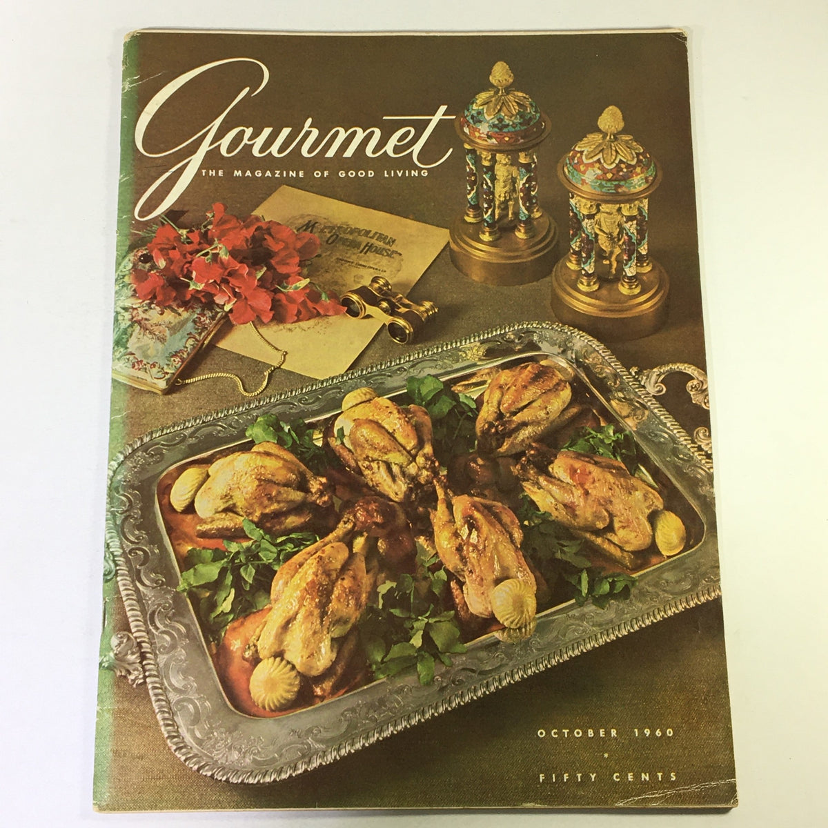 Cover of VTG Gourmet The Magazine of Good Living October 1960, featuring a vintage culinary scene with a platter of roasted quail, garnished with herbs, and elegant decorative elements.