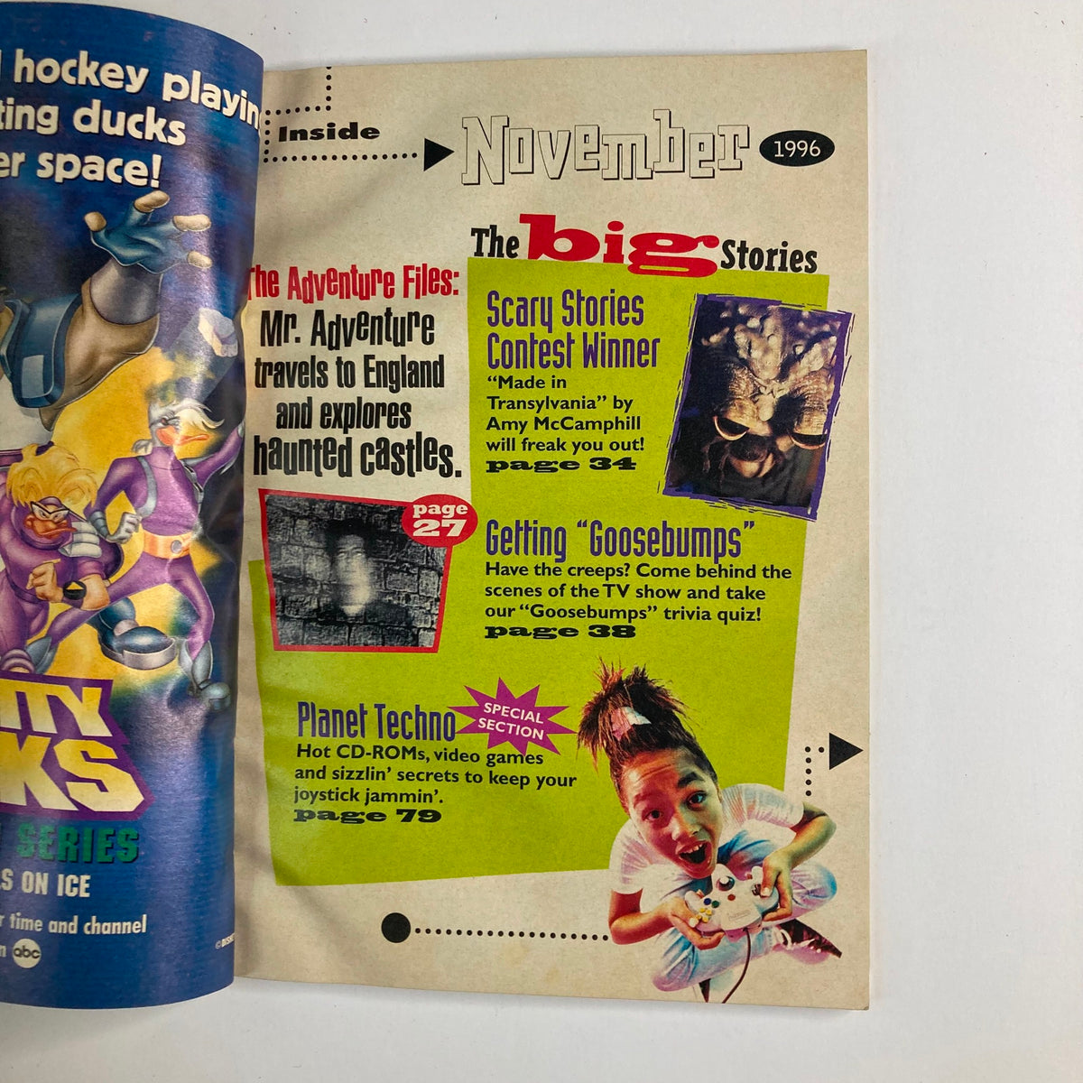 Inside page of Disney Adventures Magazine November 1996, highlighting major stories including 'The Adventure Files' and a contest winner, with colorful graphics and cartoon characters.