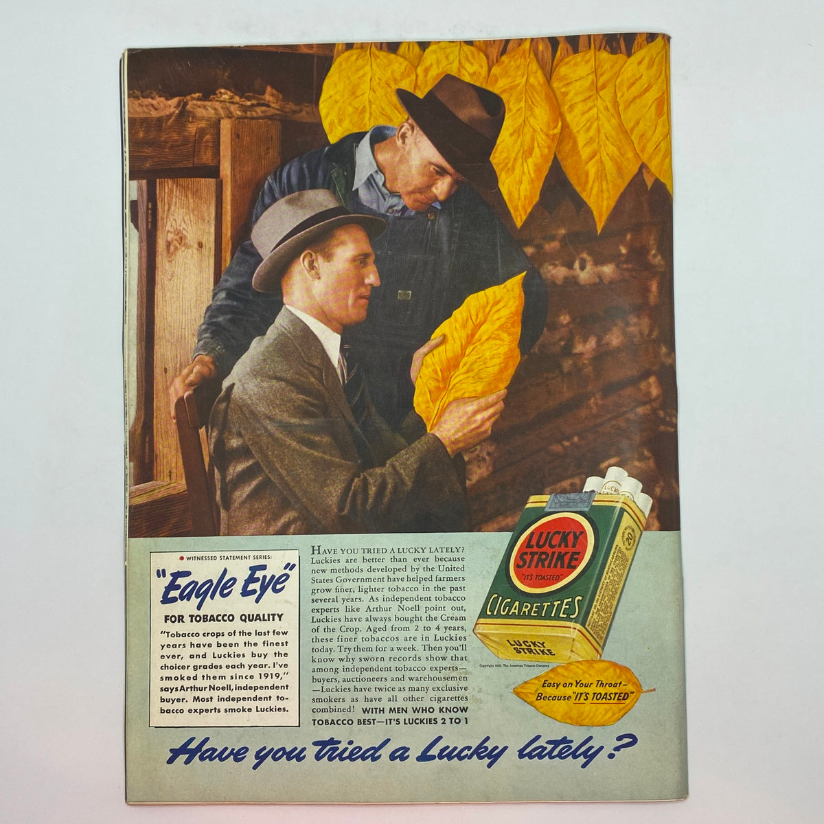 Vintage advertisement featuring two men discussing tobacco leaves, with vibrant yellow leaves in the background. This image is associated with The New Yorker Complete Magazine July 22, 1939 Rea Irvin Cover.