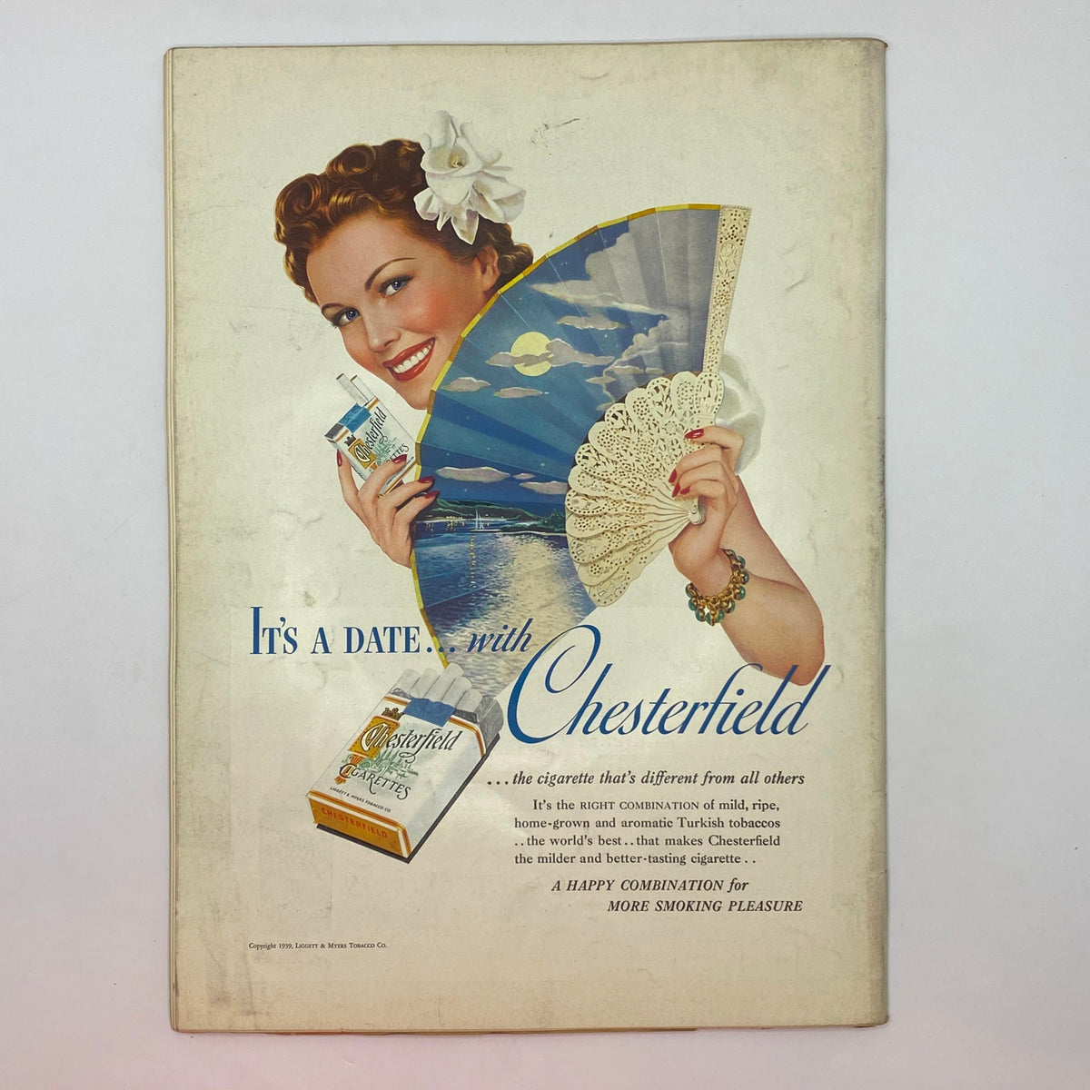 Vintage advertisement for Chesterfield cigarettes featuring a smiling woman holding a fan and a pack of cigarettes, from The New Yorker Complete Magazine September 16, 1939