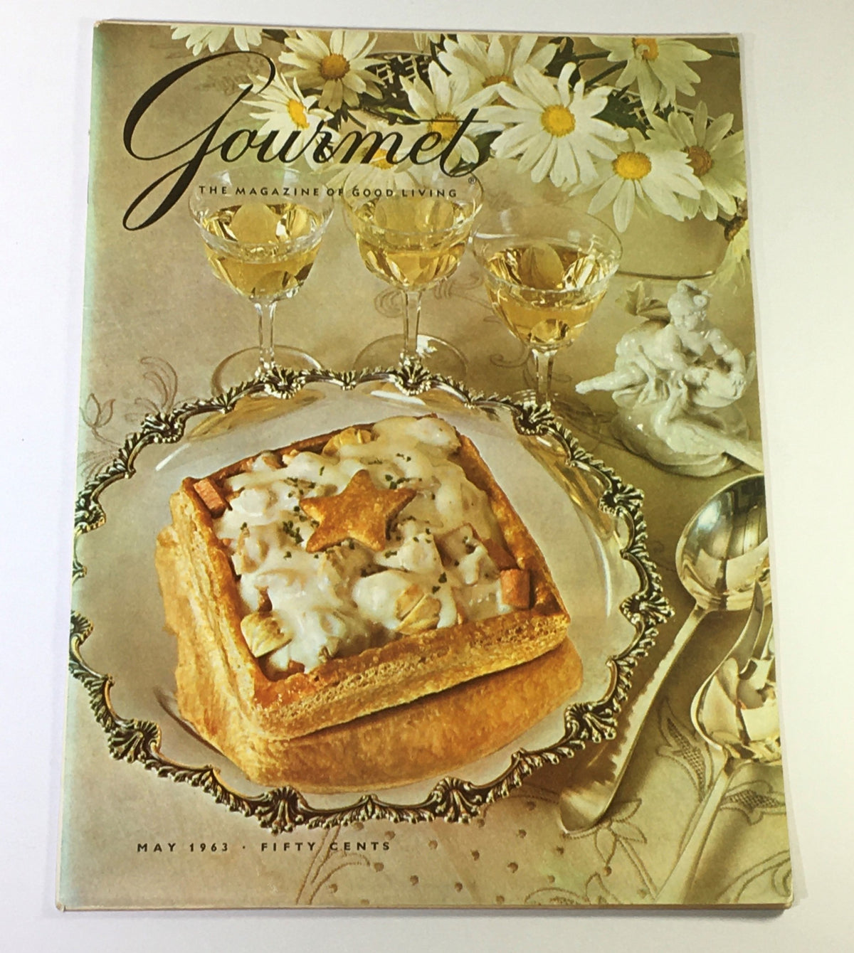 Cover of VTG Gourmet The Magazine of Good Living May 1963 showcasing a gourmet dish on a decorative plate with floral decor and elegant glassware.