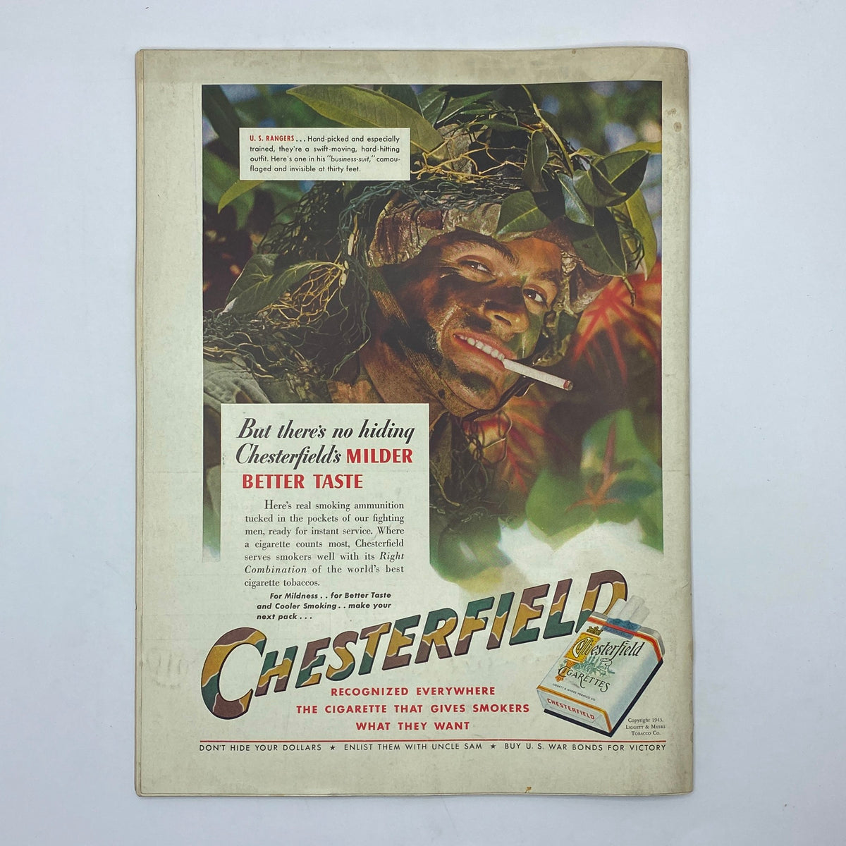 Vintage Chesterfield cigarette advertisement from The New Yorker Complete Magazine April 24, 1943 featuring a well-camouflaged soldier emphasizing the brand's message of milder taste.