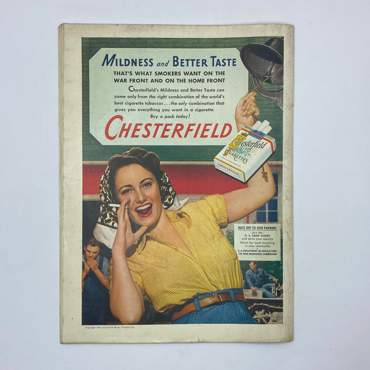 Chesterfield cigarette advertisement with a smiling woman, featured in The New Yorker magazine, May 22, 1943, highlighting wartime marketing strategies.
