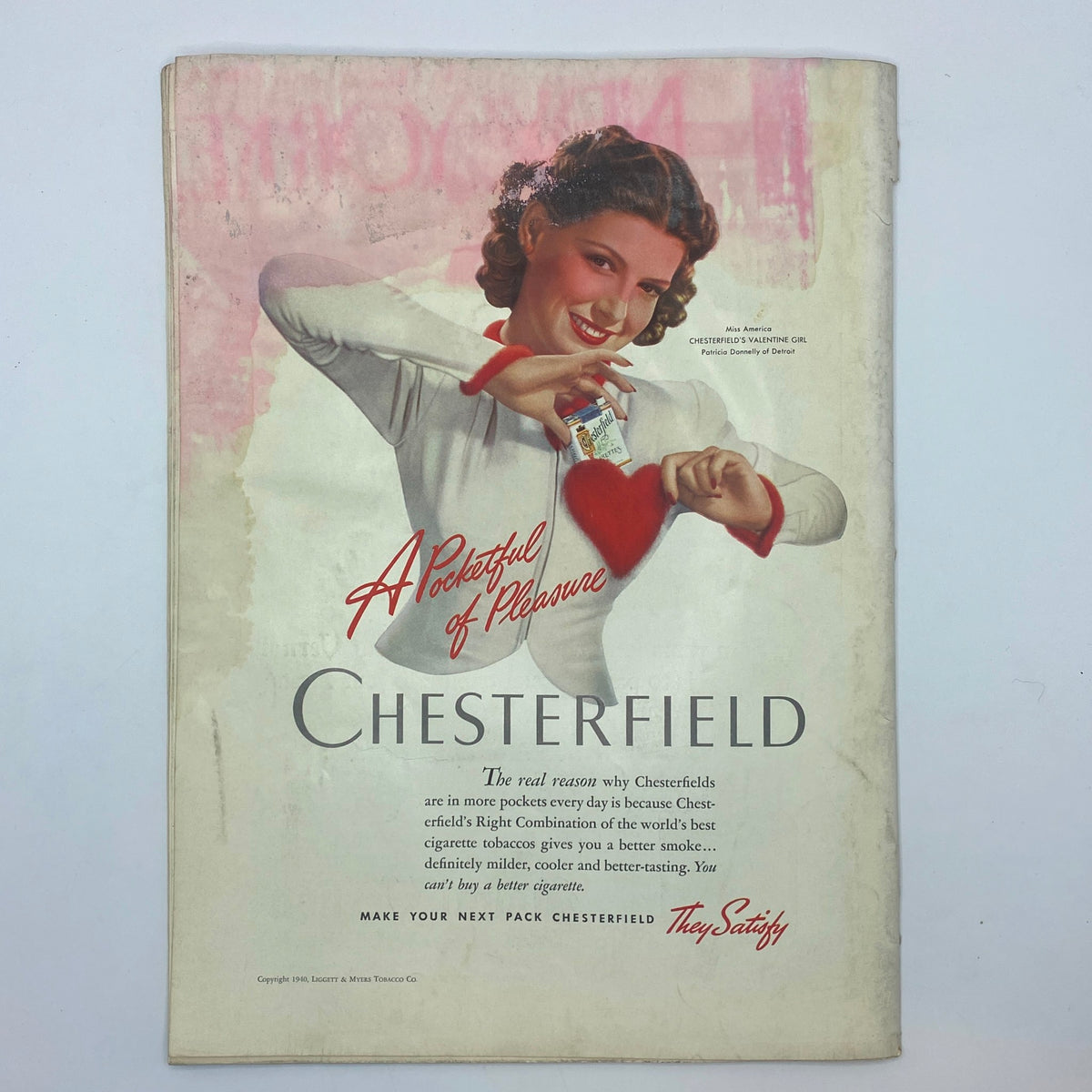 Back cover of The New Yorker Complete Magazine February 3, 1940, featuring a Chesterfield cigarette advertisement with a charming woman.
