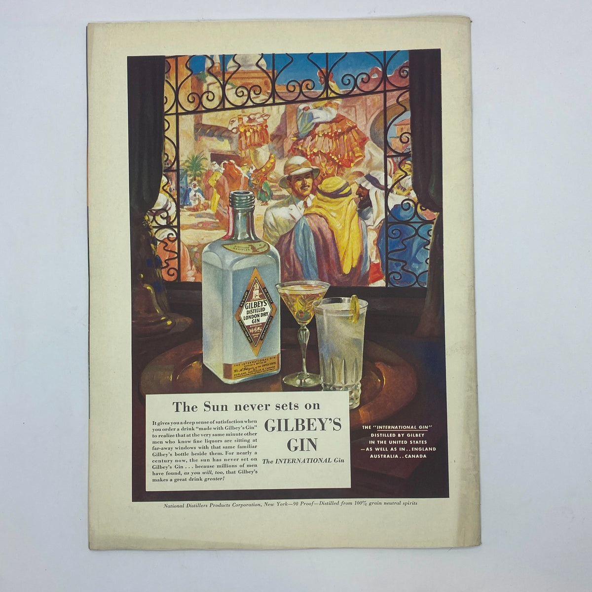 Ad for Gilbey's Gin from The New Yorker magazine, July 12, 1941, showcasing a bottle of gin and stylish cocktails, against a vibrant backdrop reflecting the allure of drinking culture.