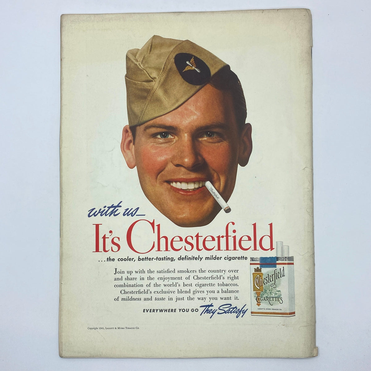 Chesterfield advertisement featuring a smiling soldier with a cigarette, promoting the cooler, better-tasting Chesterfield cigarettes, vintage ad design from the mid-20th century.