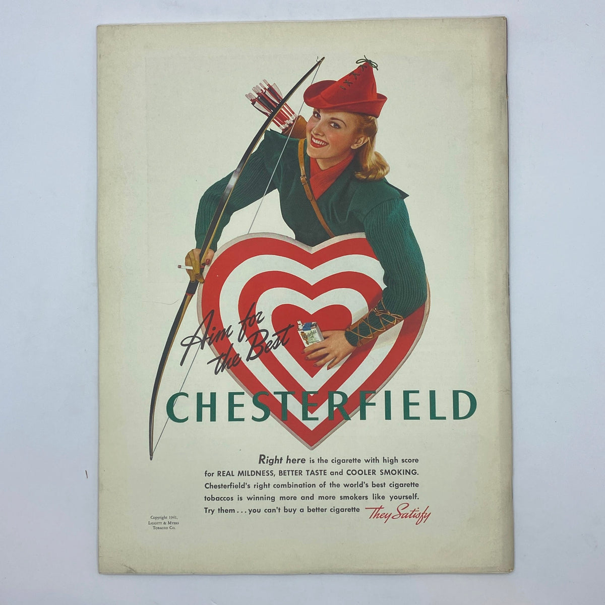 Vintage Chesterfield cigarette advertisement in The New Yorker magazine February 1, 1941, featuring a woman dressed as Robin Hood holding a cigarette and aiming for a heart target.