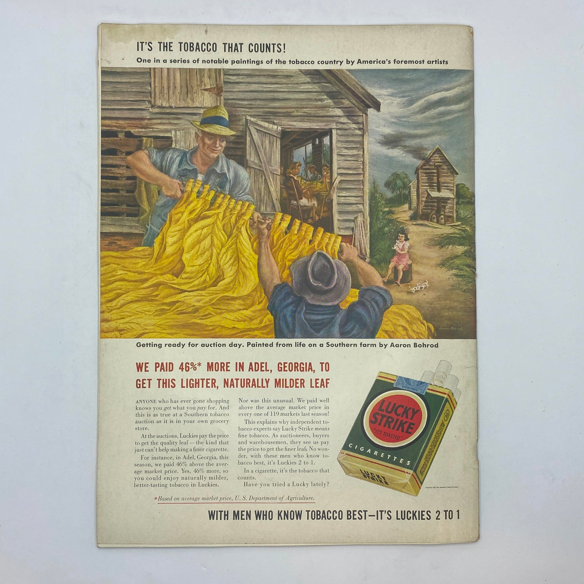Advertisement in The New Yorker magazine, February 21, 1942, featuring a painting by Aaron Bohrod, promoting Lucky Strike cigarettes with a depiction of tobacco auction preparation.