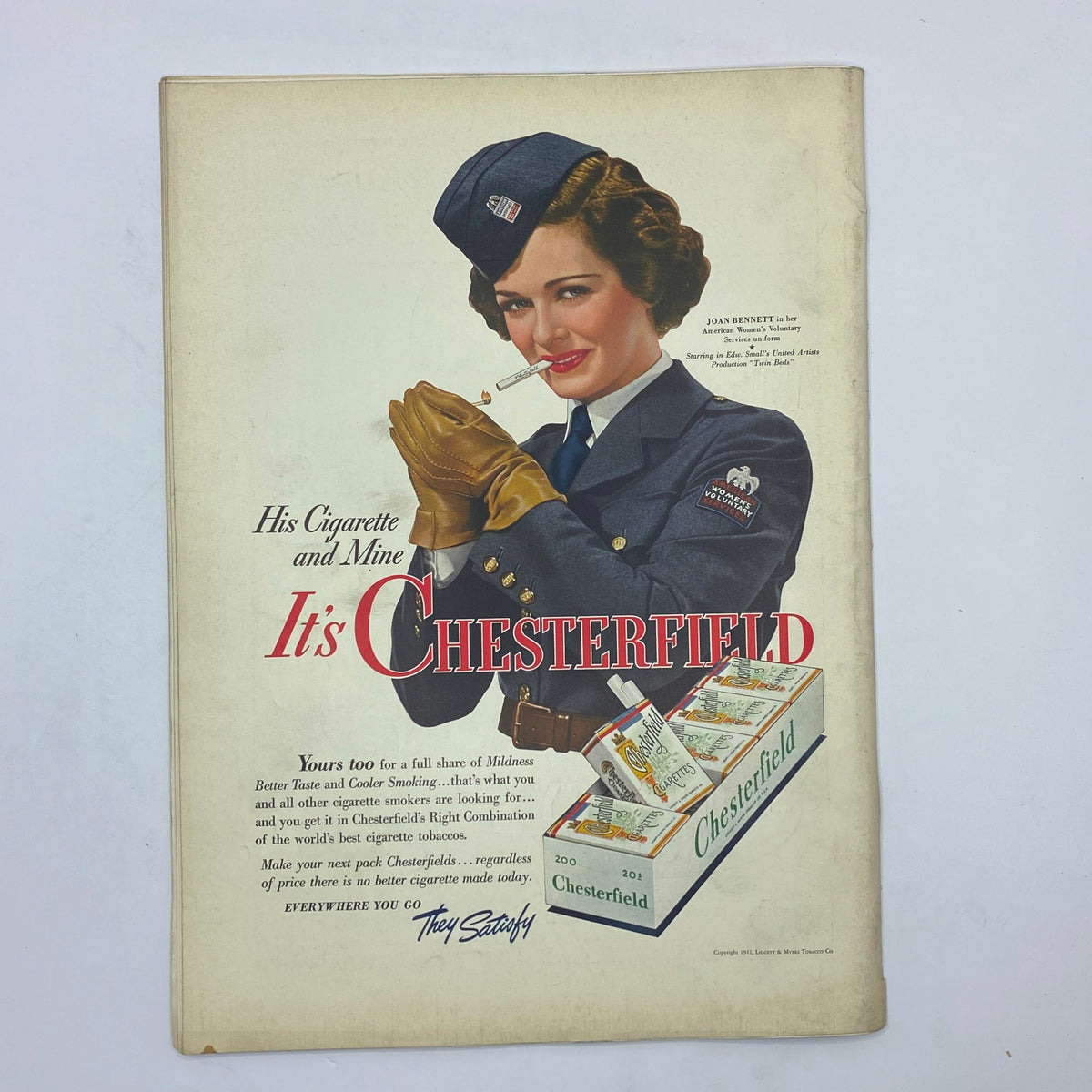 Vintage advertisement featuring a woman in a military uniform holding a cigarette with the caption 'His Cigarette and Mine It's CHESTERFIELD', reflecting mid-20th century American tobacco marketing aesthetics, connected to The New Yorker Complete Magazine March 28, 1942 Perry Barlow Cover.