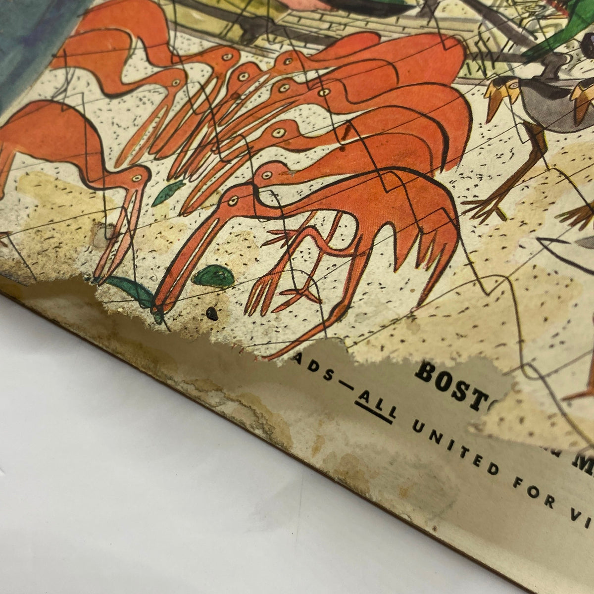 Close-up detail of the cover of The New Yorker Complete Magazine June 12, 1943 showing red flamingos at the bottom, along with signs of aging, reflective of its historical value and charm.