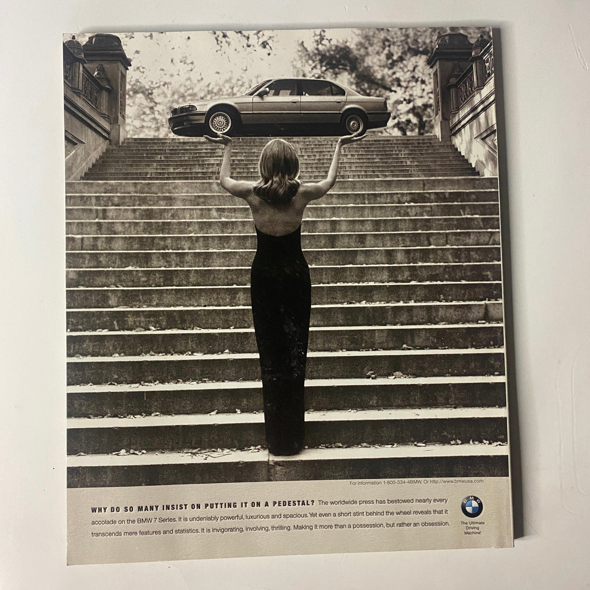 Back cover of Martha Stewart Living Magazine April 1997 featuring a vintage black and white advertisement for BMW, capturing a woman holding a vintage car on a staircase.