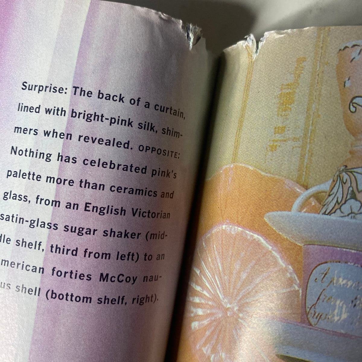 Damaged page from Martha Stewart Living Magazine February 1997, showcasing vibrant pink silk and a decorative curtain with wear at the edge.