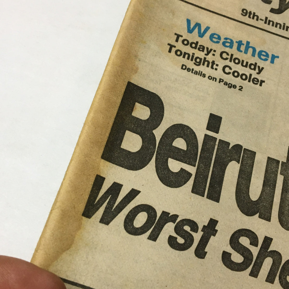 Close-up of a newspaper headline featuring 'Weather: Today: Cloudy Tonight: Cooler' with a stain, from the VTG Philadelphia Daily News July 12 1982 - Beirut Bombardment Ends in Cease-Fire.
