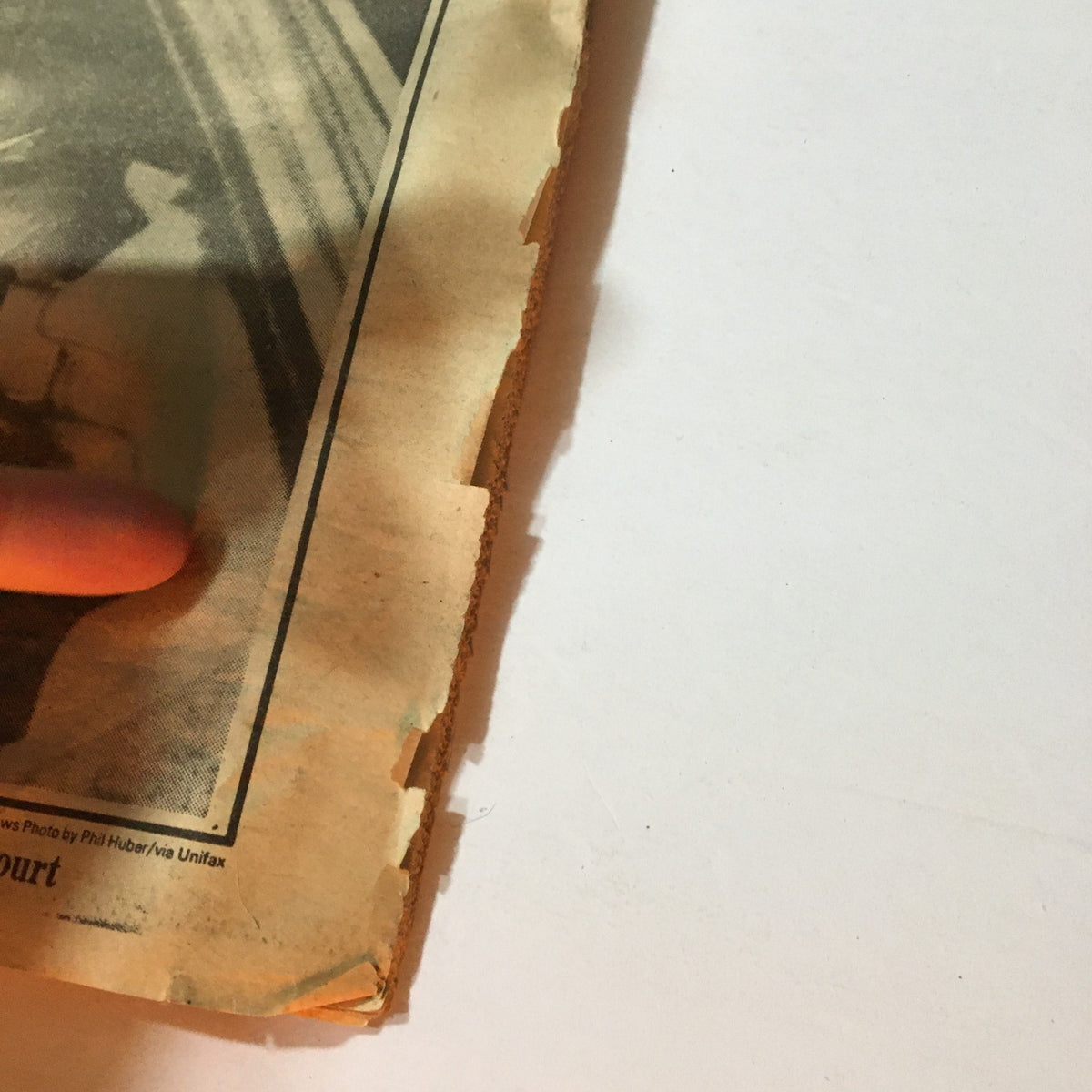 Close-up detail of the March 31, 1981, Vintage Philadelphia Daily News newspaper, showing the edge wear and condition of the article regarding John Warnock Hinckley Jr. and the assassination attempt on Ronald Reagan, highlighting some minor rips.