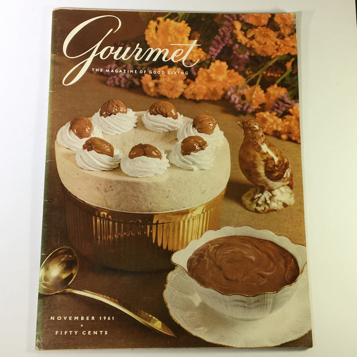 Cover of VTG Gourmet: The Magazine of Good Living, November 1961, featuring a decorative dessert with whipped cream and nuts, alongside a chocolate bowl, surrounded by flowers.