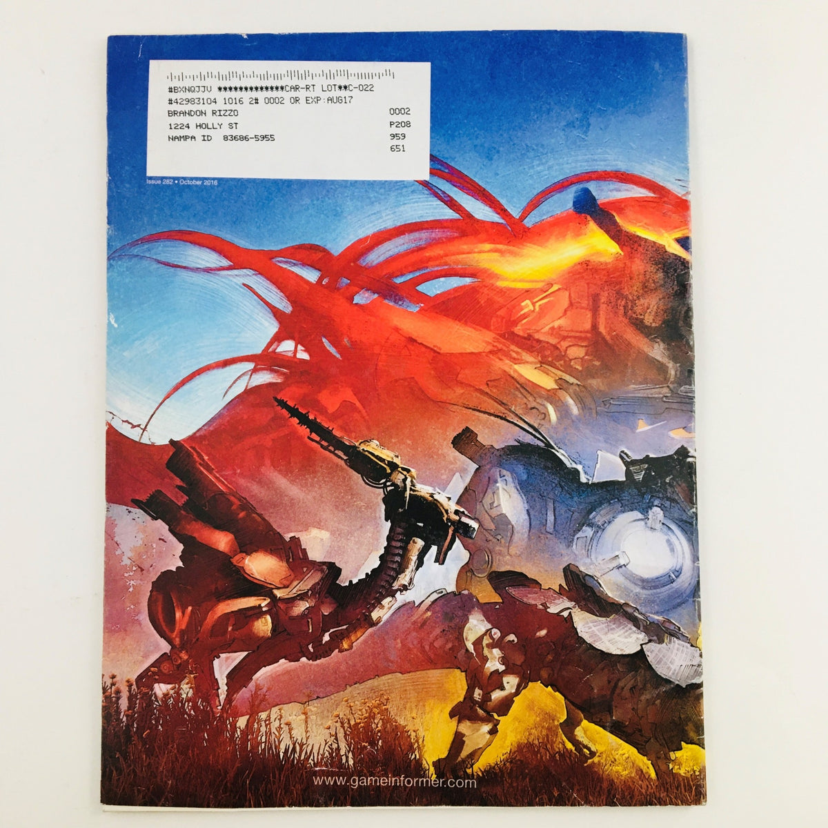 Back cover of Game Informer Magazine October 2016 Issue #282 with vibrant artwork from Horizon Zero Dawn, capturing its dynamic landscape and robotic elements.