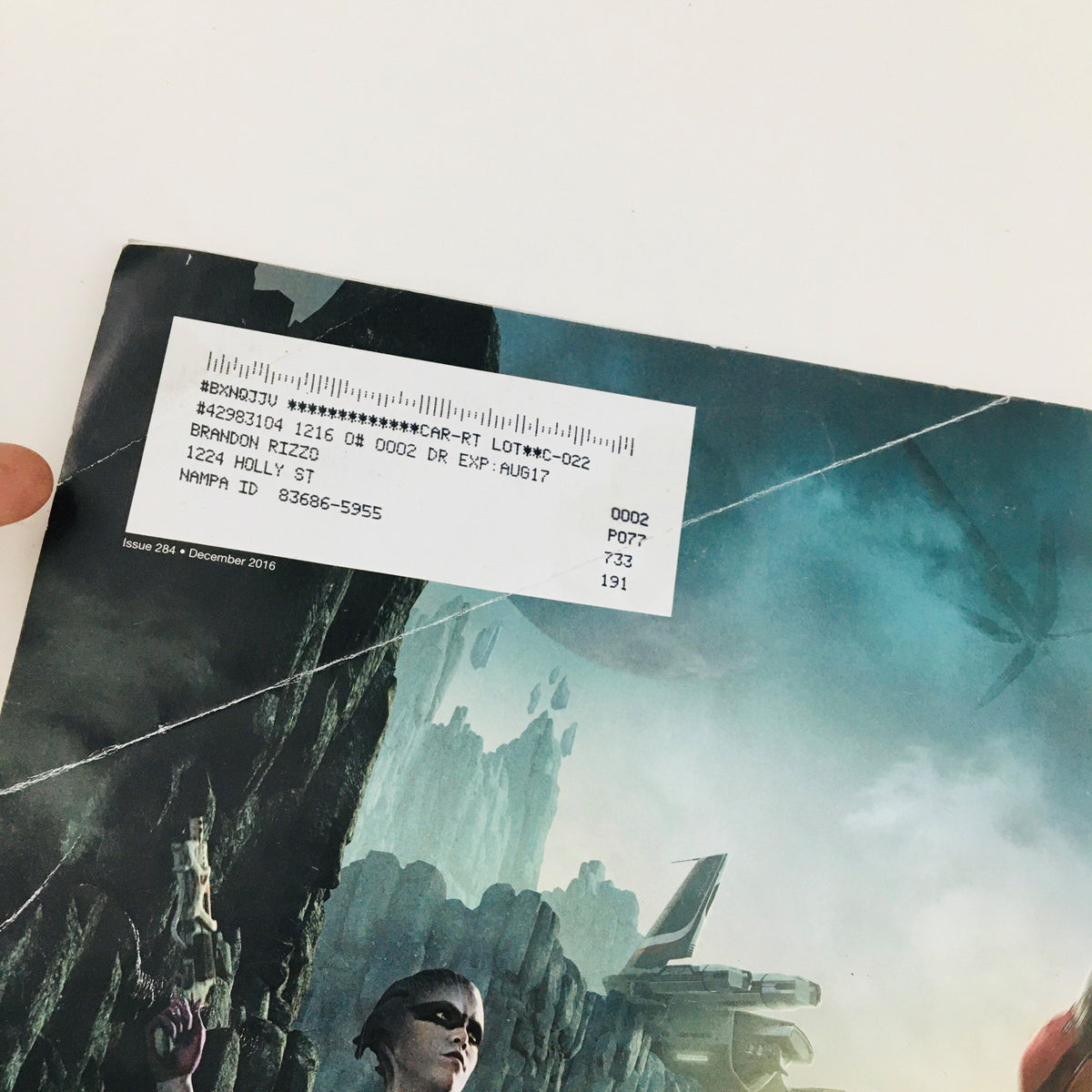 Close-up of the back cover of Game Informer Magazine December 2016 Issue 284, displaying details and an address label associated with the magazine.