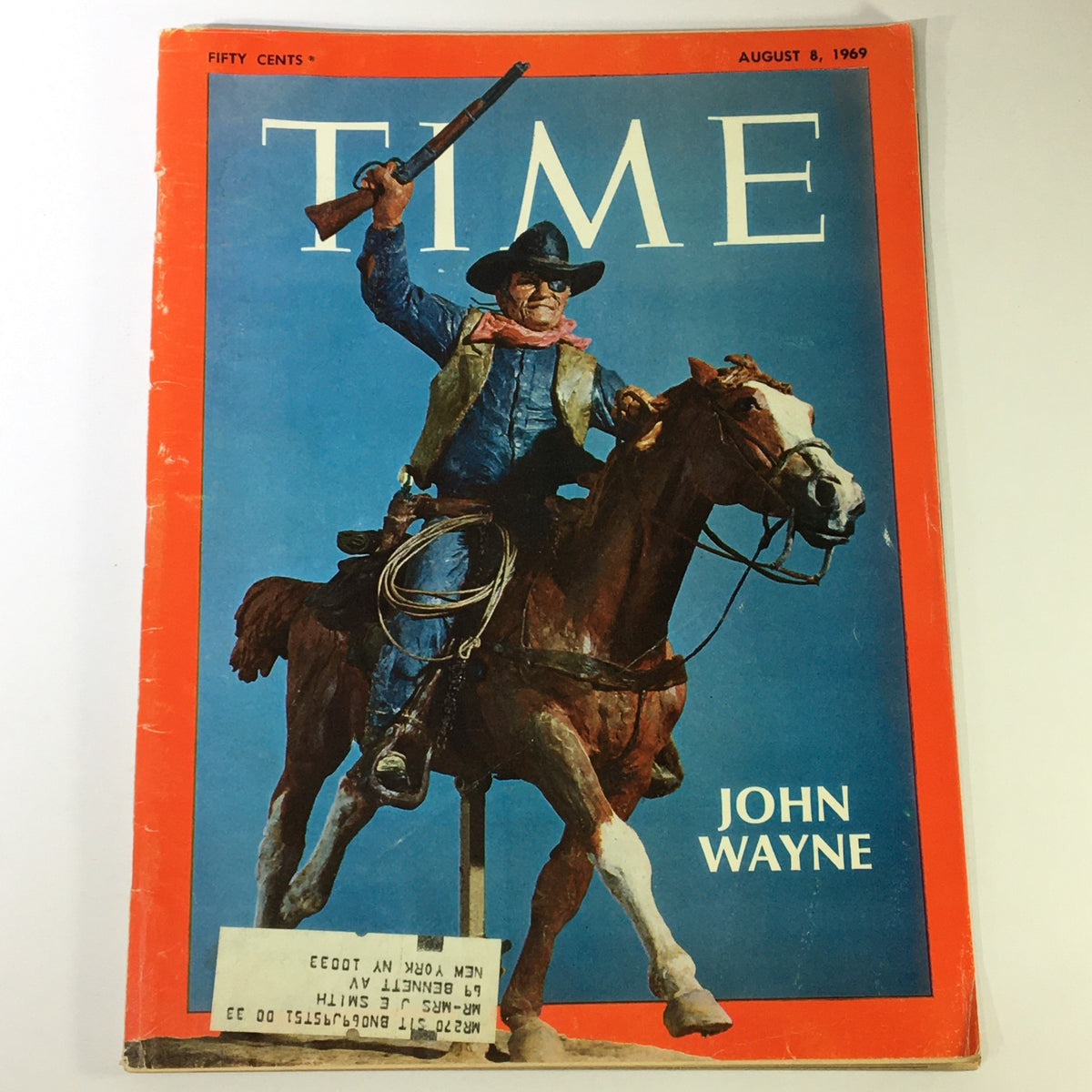 VTG Time Magazine August 8 1969 featuring John Wayne, depicted as the King of Western Films, on the cover. The magazine shows a cowboy holding a rifle while riding a horse, with notable vintage aesthetics and an address label present.