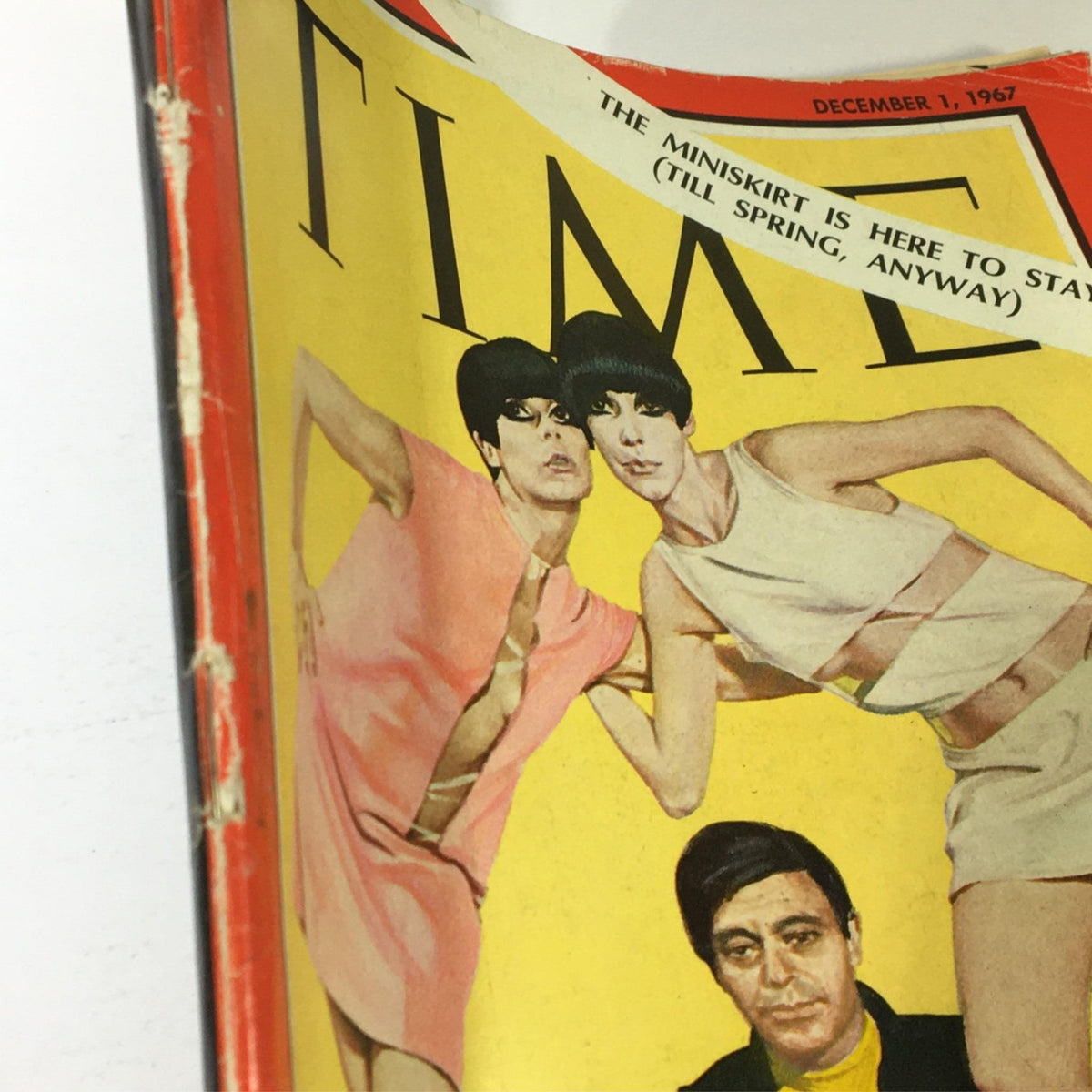 Oblique view of the Vintage Time Magazine cover from December 1, 1967, illustrating the cover art of fashion designer Rudi Gernreich with models in stylish outfits and the text about the miniskirt.