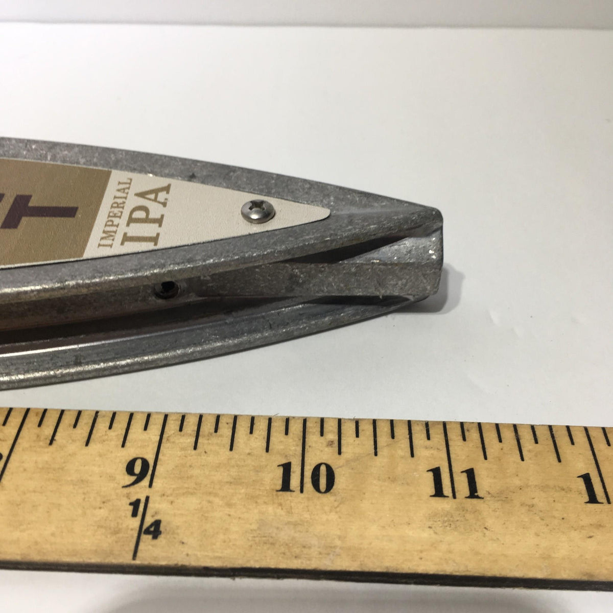 Close-up view of the Vintage New Belgium Brewing Rampant Imperial IPA 11" Beer Tap Handle showing the spout and measuring scale.