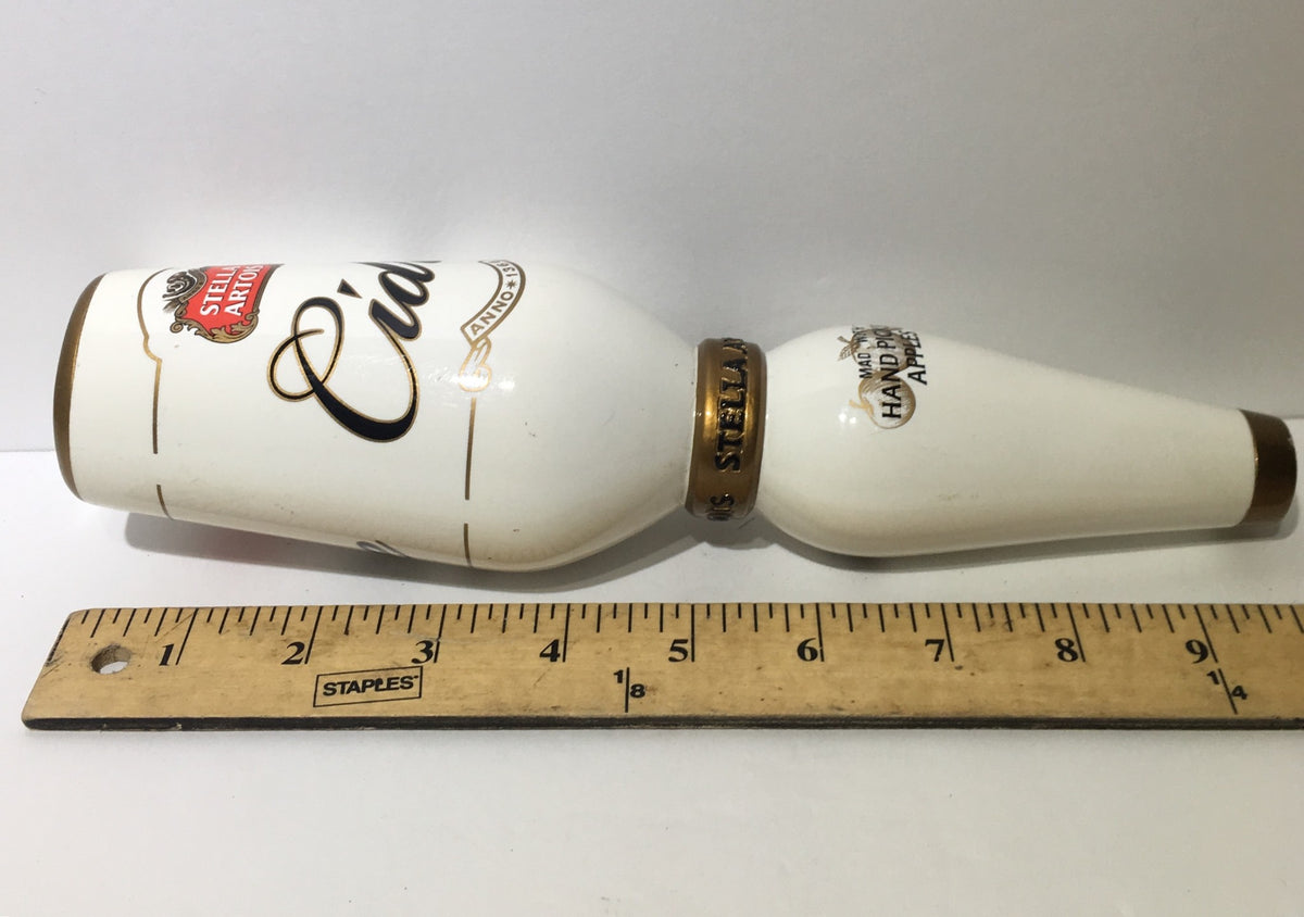 Side view of the Vintage Stella Artois Cidre 10" Beer Tap Handle next to a ruler, emphasizing its size and vintage appeal.