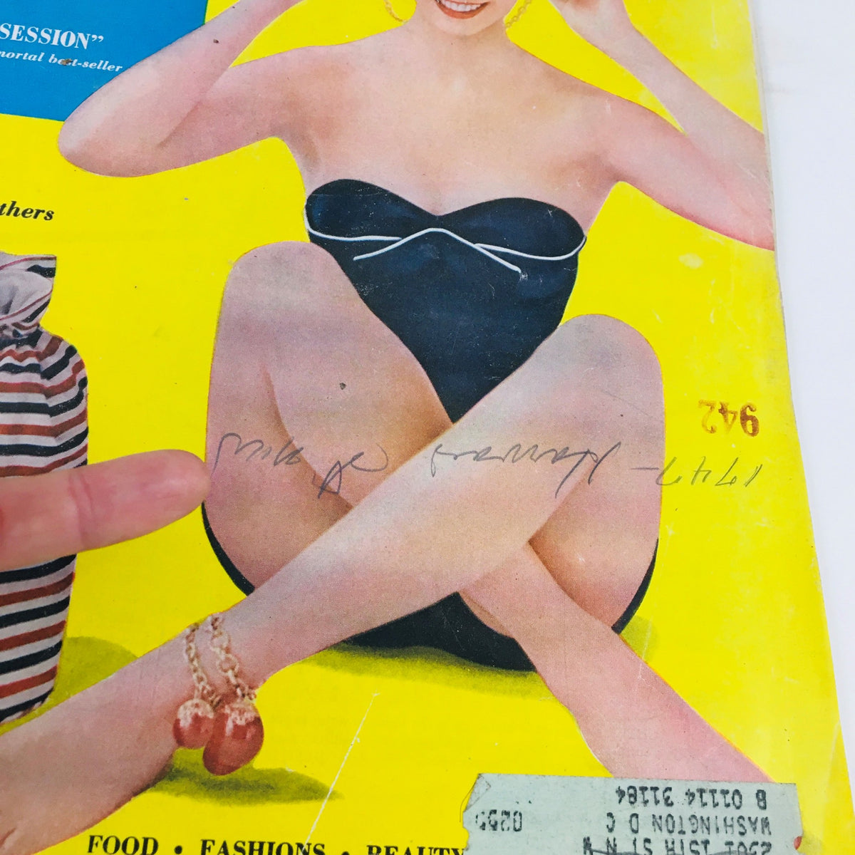 Detailed close-up of the Woman's Home Companion August 1954 magazine cover highlighting a woman's leg adorned with a bracelet and sunbathing style.
