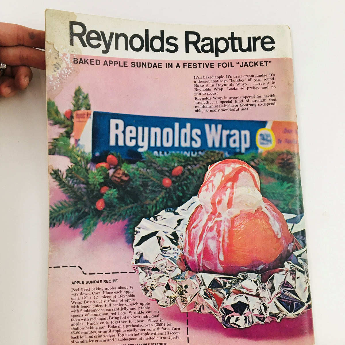 Cover of The Saturday Evening Post Winter 1973 featuring a recipe for a baked apple sundae, highlighted with Reynolds Wrap. This vintage magazine includes festive holiday decor and instructions for preparing a delicious dessert.