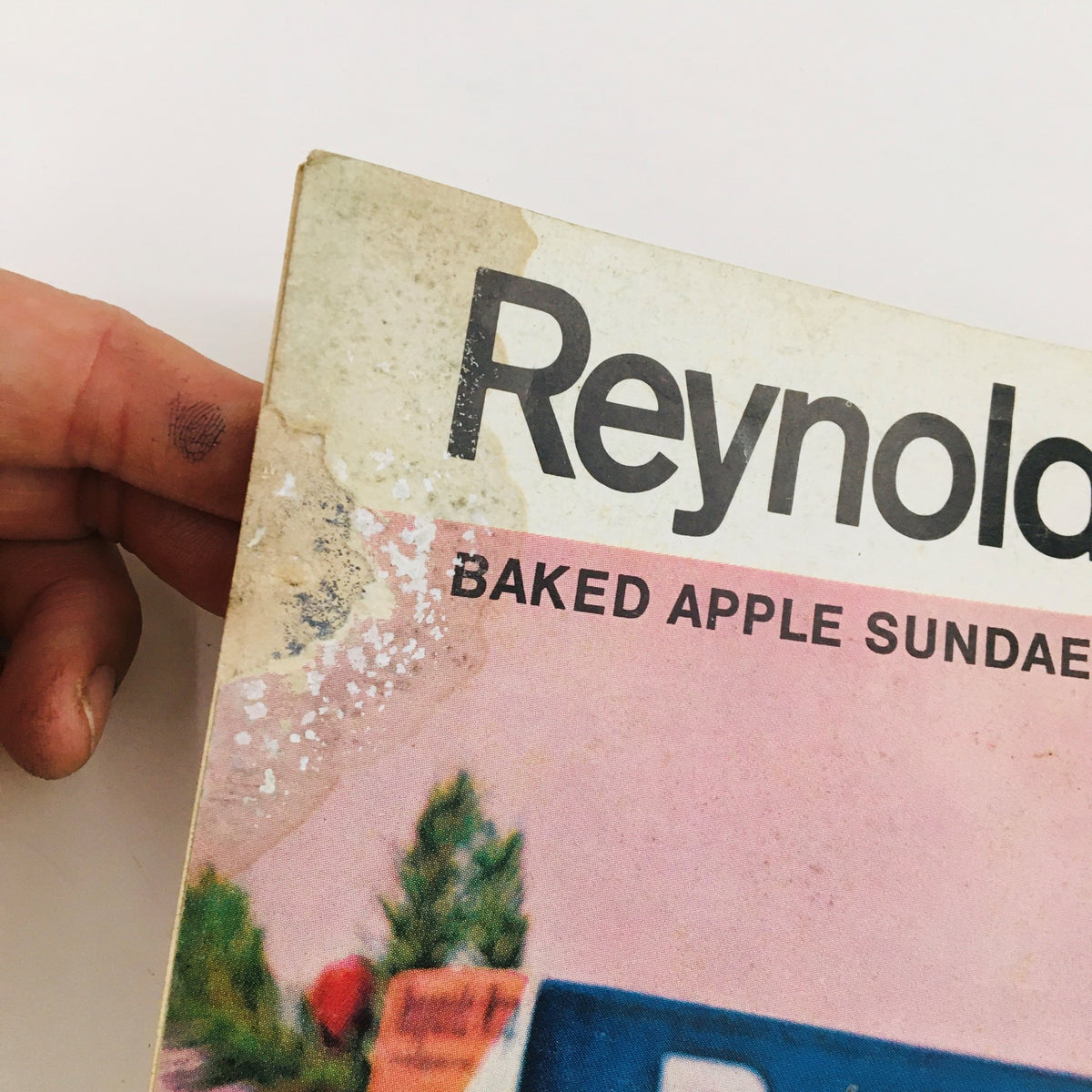 Close-up view of the cover of The Saturday Evening Post Winter 1973, showcasing the baked apple sundae recipe. The cover displays wear with age, maintaining the title and vintage aesthetic related to holiday cooking.