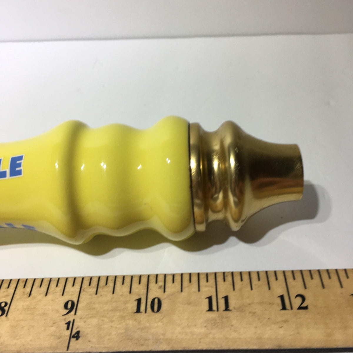 Close-up of the base of Vintage Brooklyn Summer Ale 12½" beer tap handle, showing the golden finish and measurement for size reference.