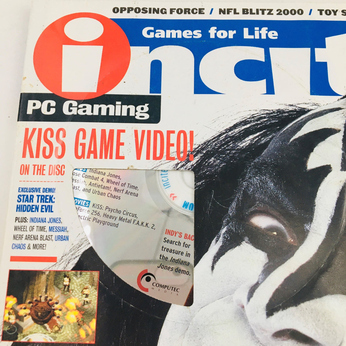 Close-up of Incite Magazine February 2000 displaying the title and a promotional disc for Kiss: The New Game.