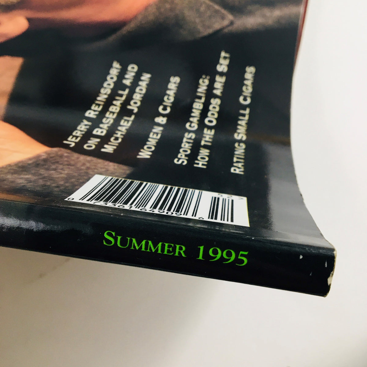 Spine view of the Summer 1995 issue of Cigar Aficionado Magazine, showcasing the title and date 'Summer 1995' alongside other featured articles related to cigars and sports, linked to the theme 'Cigar Aficionado Magazine Summer 1995: Jack Nicholson - Hollywood Rogue'.