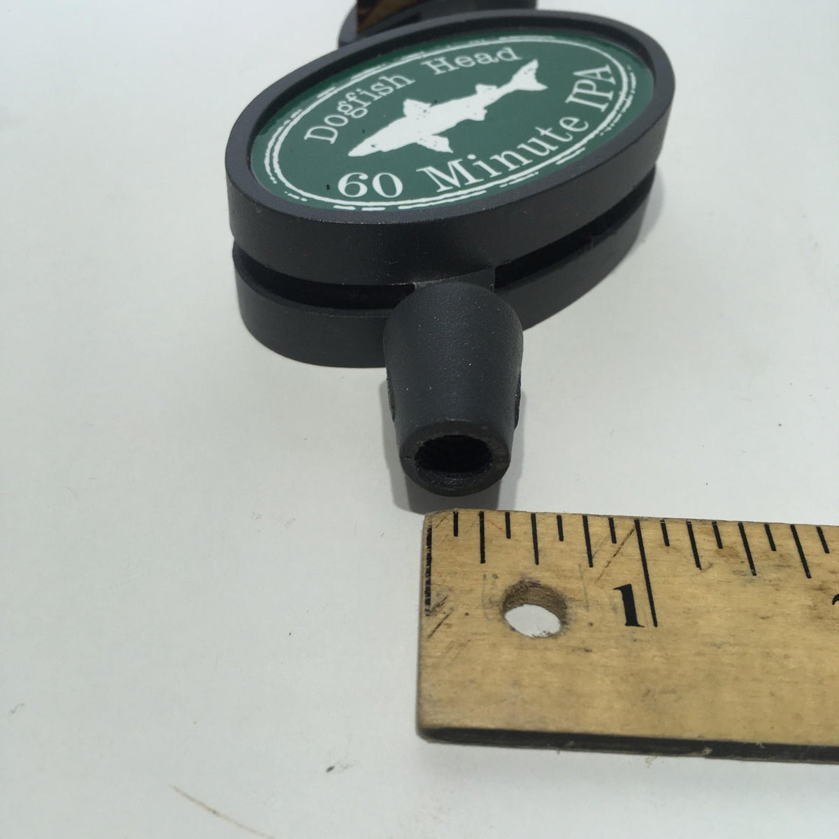 Detailed shot of the Vintage Dogfish Head 60 Minute IPA 12" Beer Tap Handle showcasing the tap connection and scale with a ruler for reference.
