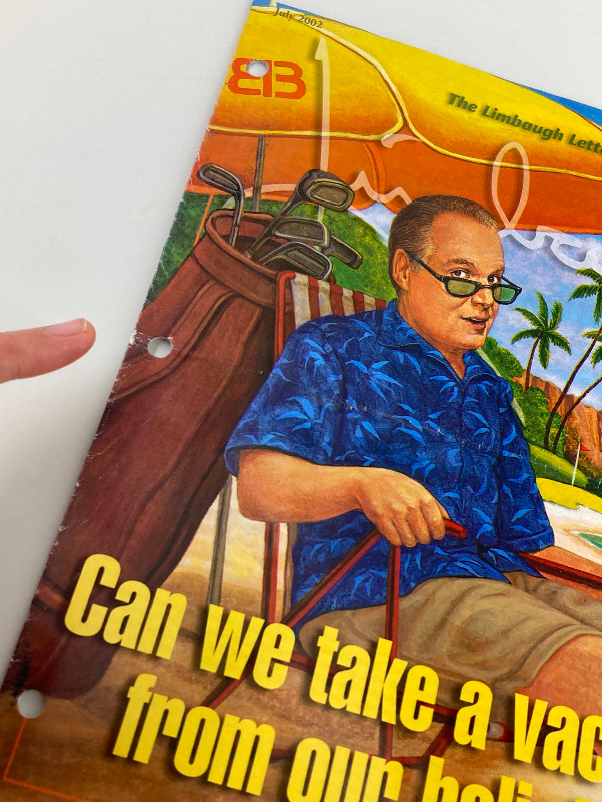 Close-up of the Rush Limbaugh Letter Newsletter Magazine cover from July 2002, highlighting the title 'Can We Take A Vacation from Our Beliefs?' with vibrant artwork showcasing a beach scene and a man in golf attire.