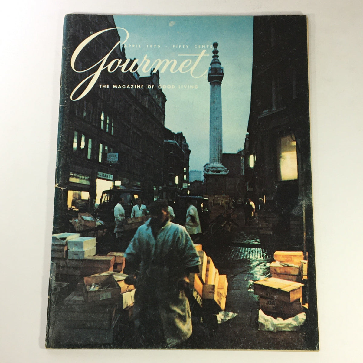 Cover of the Vintage Gourmet Magazine of Good Living from April 1970 featuring an urban street scene with a monument, showcasing the title 'Gourmet: The Magazine of Good Living'.