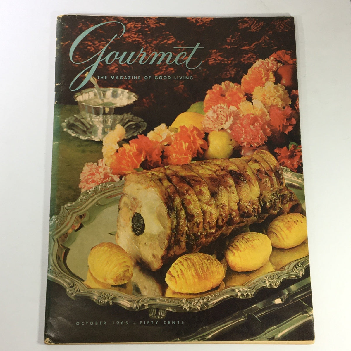 Cover of VTG Gourmet The Magazine of Good Living October 1965 featuring a beautifully arranged plate of sliced roast with potatoes and flowers, showcasing vintage culinary art.